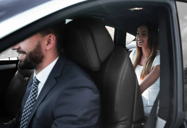 Handsome bearded businessman is sitting in a new car — Stock Photo, Image
