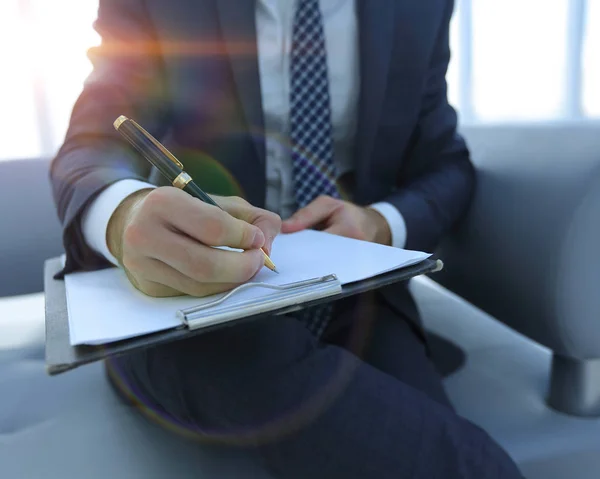 Businessman signs a contract. Holding pen in hand. — Stock Photo, Image