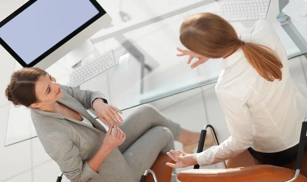 View from the top rear.business woman talking with a colleague sitting near the desktop — Stock Photo, Image