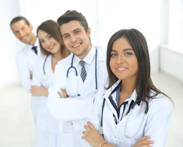 Female doctor with group of happy successful colleagues — Stock Photo, Image