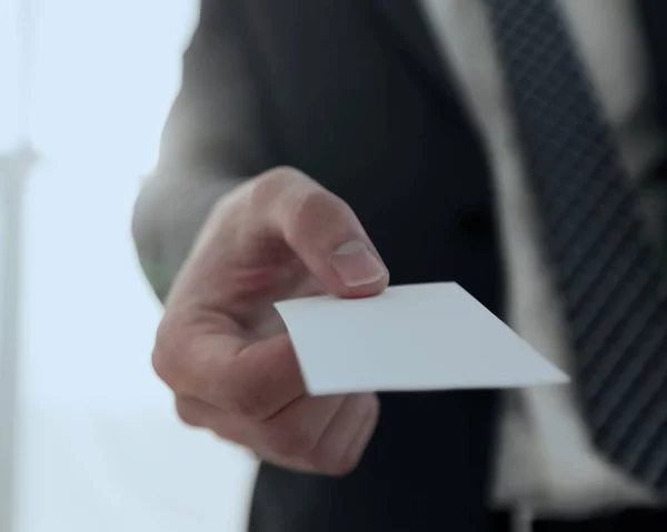 Zakenman geven visitekaartje op lichte achtergrond — Stockfoto