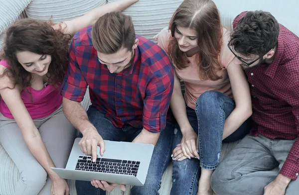 Grupo de amigos con un ordenador portátil, discutiendo el video — Foto de Stock
