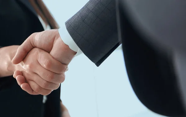 Close up of businessman and businesswoman shaking hands