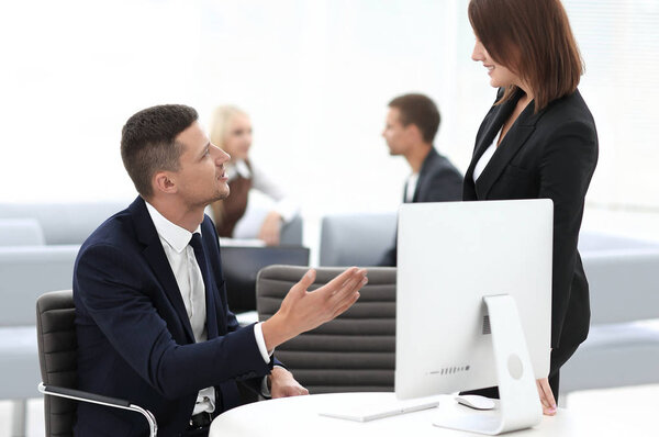 employees sitting behind a Desk in the office