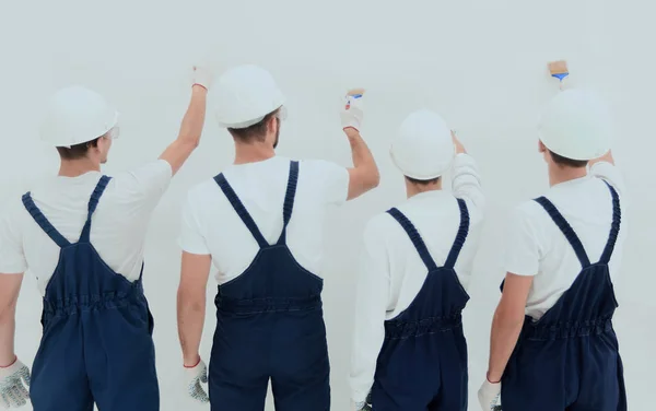 Trabalhadores view.construction traseiro pintar a parede . — Fotografia de Stock