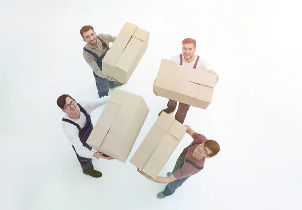 Movers lifting stack of cardboard moving boxes isolated on white — Stock Photo, Image