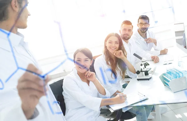View through the transparent Board. a scientist makes a report. — Stock Photo, Image