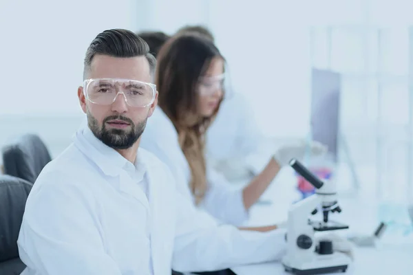 Microbiologista e seus colegas estão sentados em um laboratório moderno — Fotografia de Stock