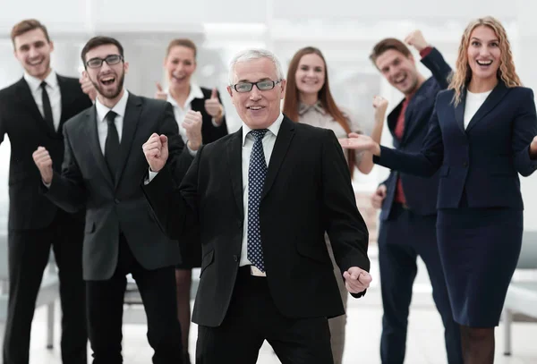 Happy senior businessman and triumphant business team — Stock Photo, Image