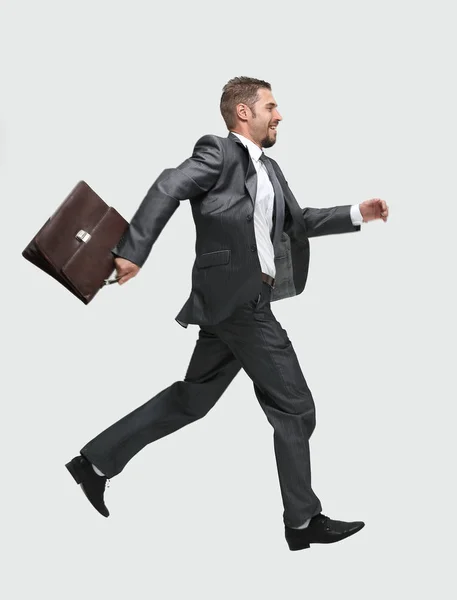 Lado view.cheerful hombre de negocios con maletín dando un paso adelante —  Fotos de Stock