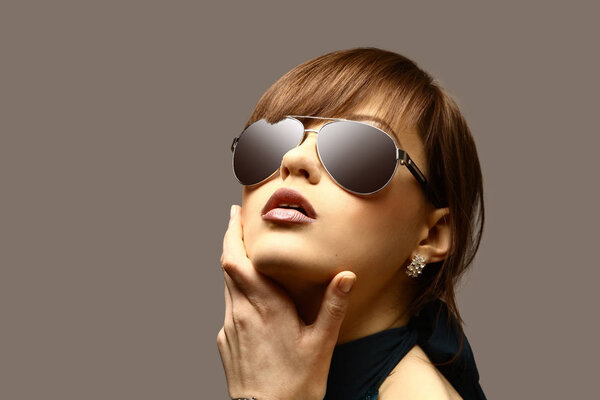 face of young woman in dark glasses.