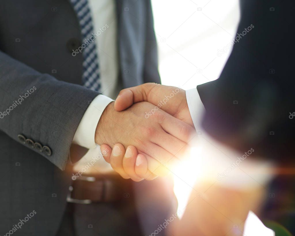 Businessman giving his hand for handshake to partner