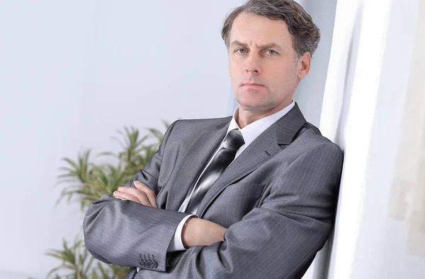 Successful businessman on background of office. — Stock Photo, Image