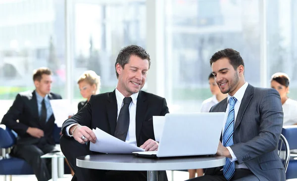 Business partners discussing a new project, sitting in the lobby of the office. — Stock Photo, Image