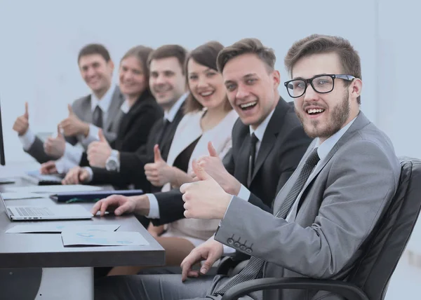 Business team with thumbs up while sitting at his Desk — Stock Photo, Image