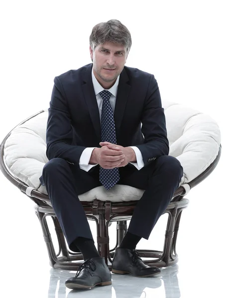 Tired business man sitting in a large comfortable chair — Stock Photo, Image