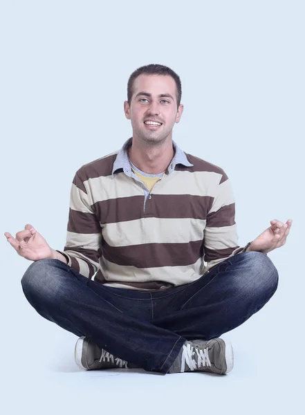 Современный молодой человек, сидящий на полу — стоковое фото