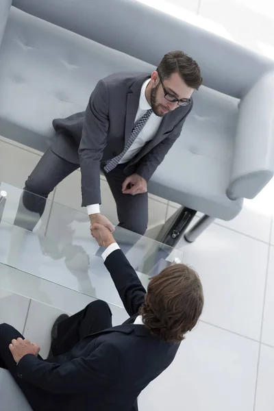 Colleagues shaking hands in office — Stock Photo, Image