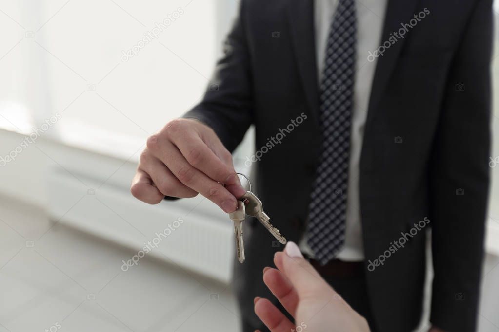 Estate Agent Giving House Keys To Person