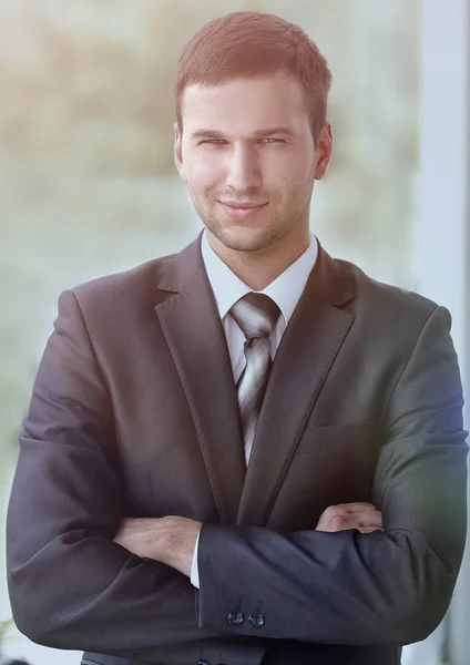 Successful businessman standing near window in office. — Stock Photo, Image