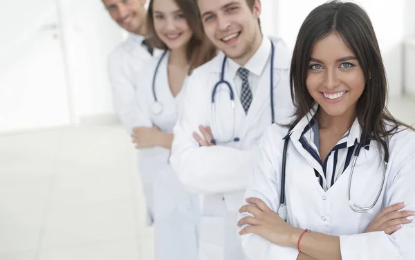 Female doctor with group of happy successful colleagues — Stock Photo, Image