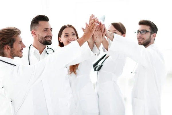 Group of doctors giving each other a high five. — Stock Photo, Image