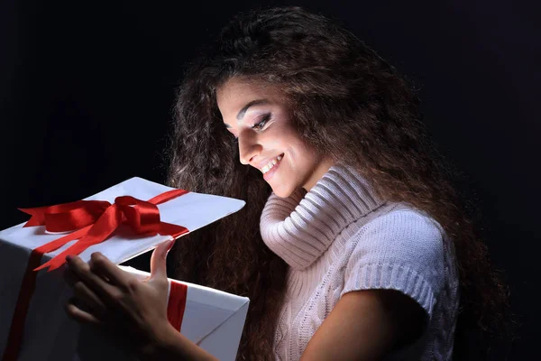 Retrato de uma bela jovem morena espreitando em uma caixa de presente — Fotografia de Stock