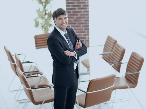 Business man standing in an empty meeting room — Stock Photo, Image