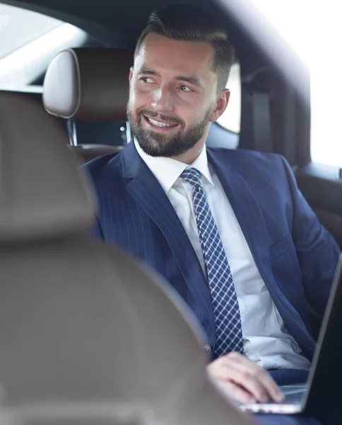 Close-up of a successful businessman sitting in a car — Stock Photo, Image