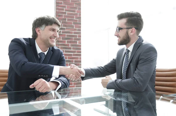 Business partners shake hands after discussing the contract Stock Picture