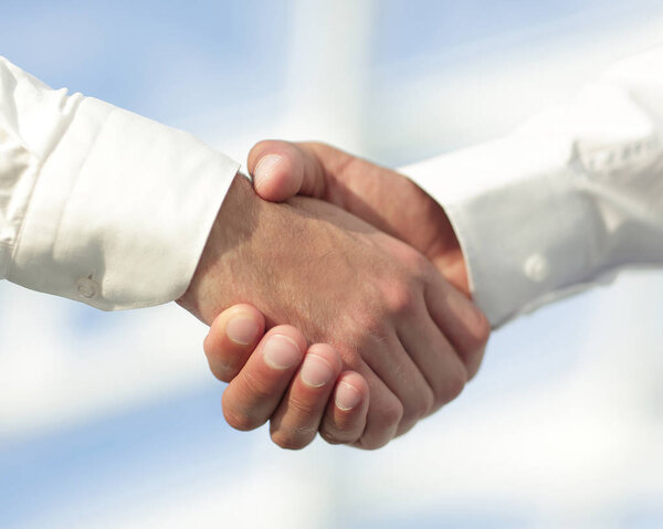 Close-up photo of handshake of two successful businessmen