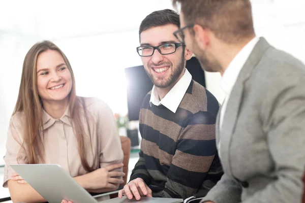 Three happy employees working on line with a tablet — Stock Photo, Image