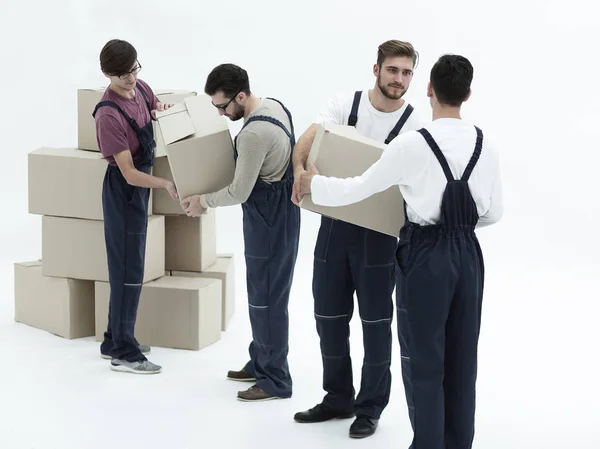 Movers lifting stack of cardboard moving boxes isolated on white — Stock Photo, Image