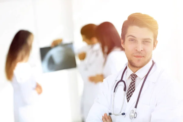 Joven doctor en el fondo de colegas —  Fotos de Stock