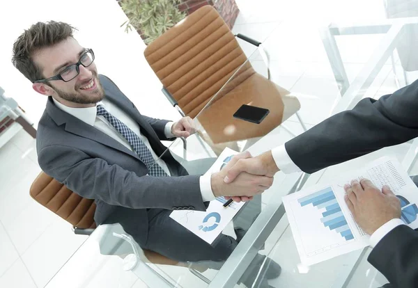 Handshake affärspartners vid skrivbordet — Stockfoto