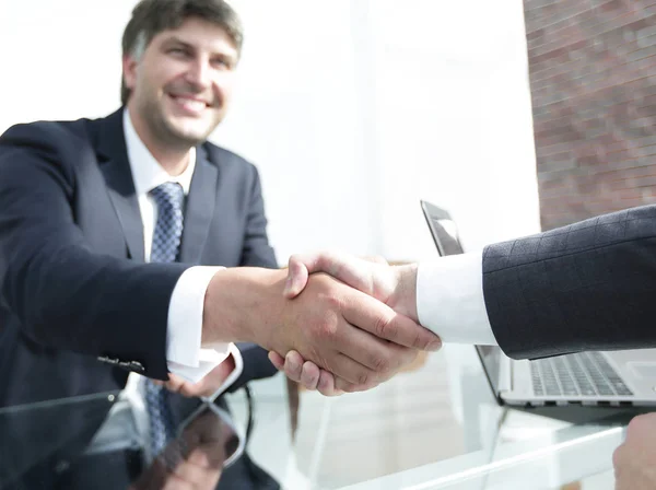 businessman stretches out his hand for a handshake