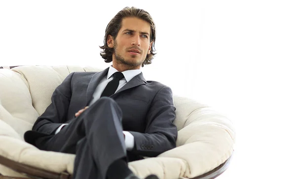 Confident businessman sitting in a large comfortable chair. — Stock Photo, Image