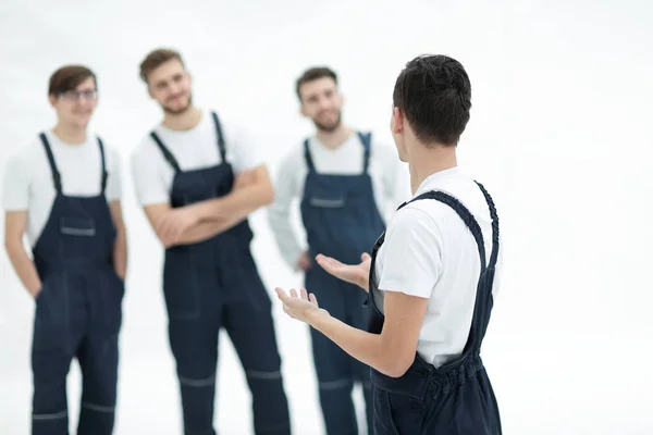 Cheerful team of responsible movers and their smiling leader. — Stock Photo, Image