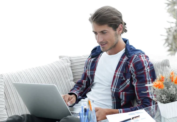 surprised young man working with laptop from home.