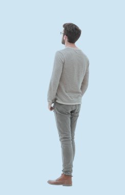 Arka görüş. Tam uzunlukta. Gri süveterli genç adam