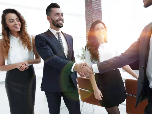 Handshake of business people on the background of the office — Stock Photo, Image