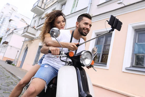 Glückliches Paar auf Roller macht Selfie auf Smartphone im Freien — Stockfoto