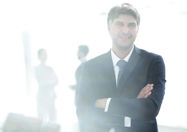 Portrait of confident businessman on office background — Stock Photo, Image