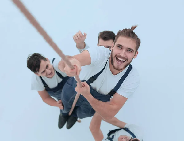 Visa från top.smiling ingenjören, klättra upp repet — Stockfoto