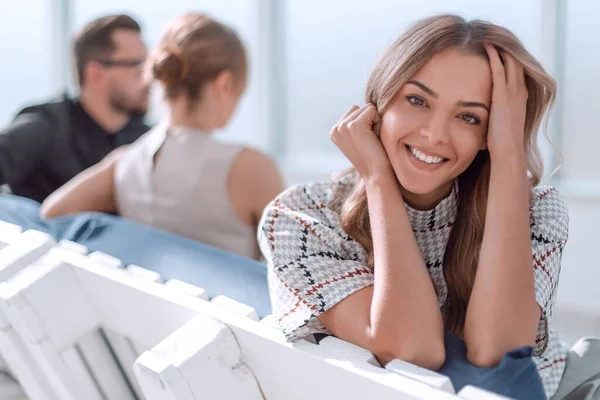 young business woman sitting in office lobby at coffee break