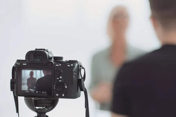 Background image is a camera filming an interview in Studio — Stock Photo, Image