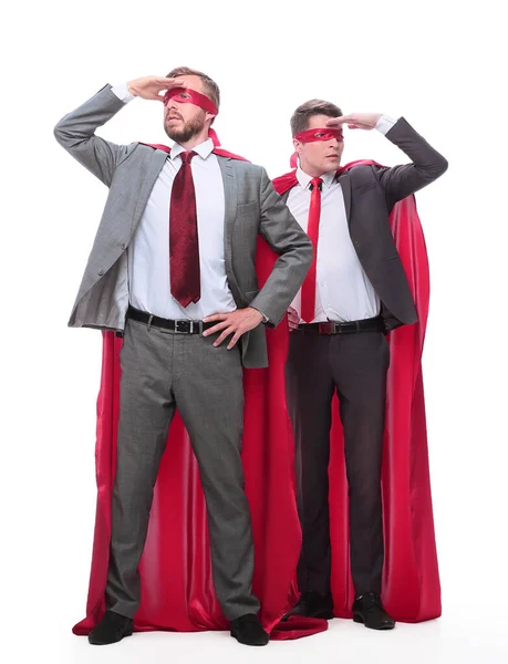 Two businessmen in superhero raincoats looking in different directions. — Stock Photo, Image