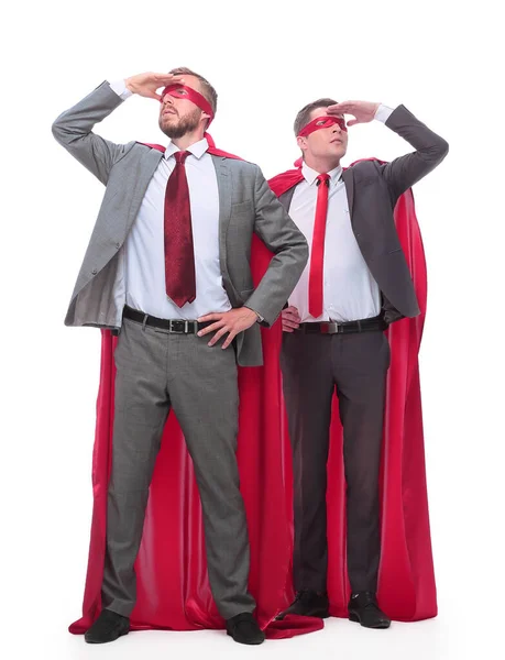Two businessmen in superhero raincoats looking in different directions. — Stock Photo, Image