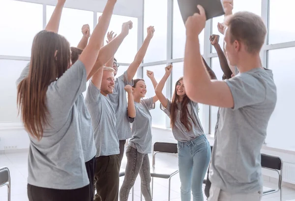 Happy group of young people standing in the conference room — Stock Photo, Image