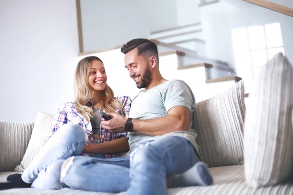 Loving couple sitting on sofa in cozy living room — Stock Photo, Image